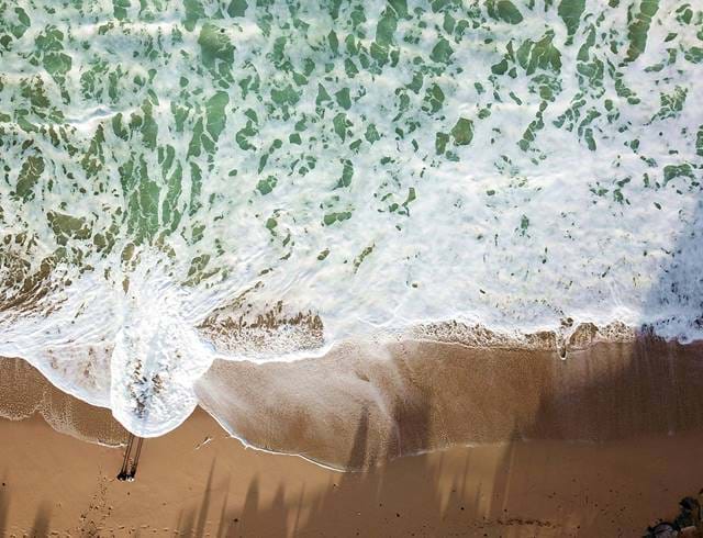 Drone image of waves breaking on a beach