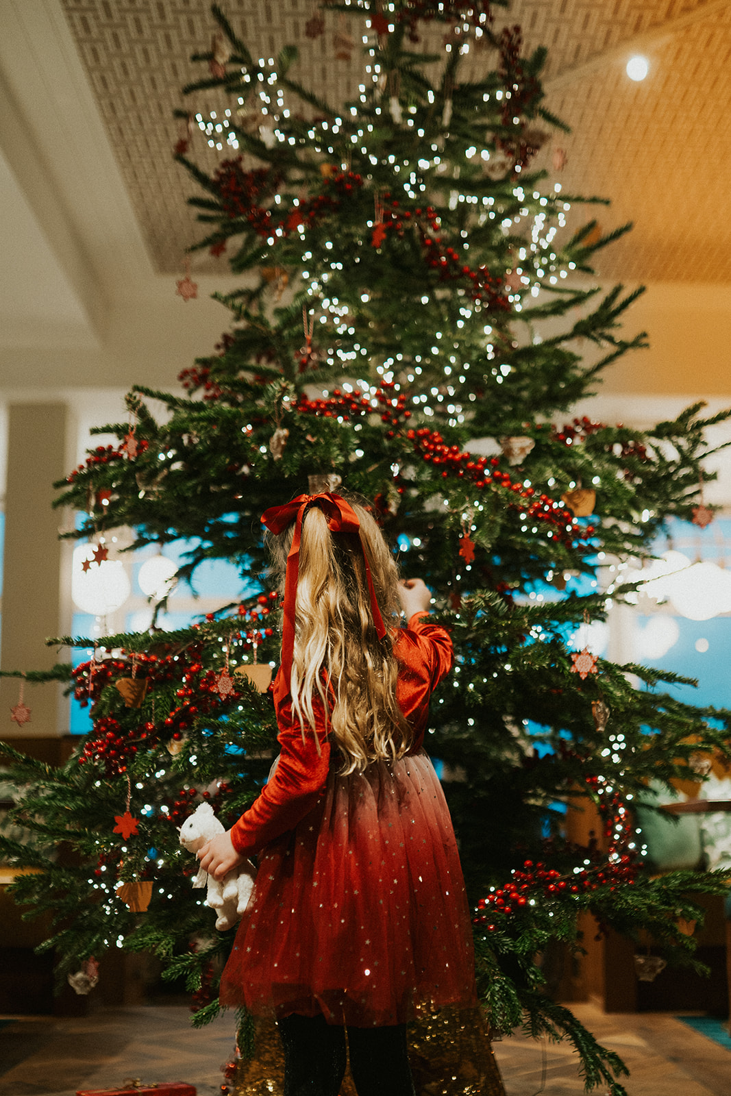 A child taking a decoration from the tree