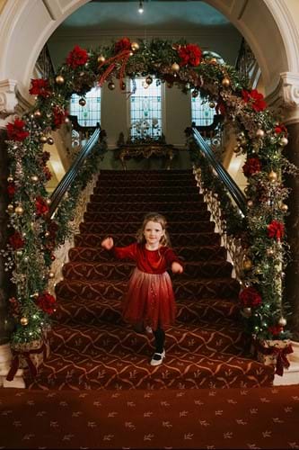 Girl on Christmas staircase